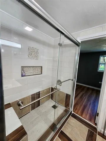 a bathroom with a toilet a sink and shower
