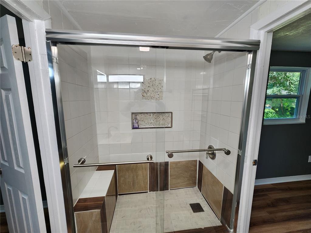 106 Southwest 6th Street Micanopy, FL 32667 - Photo 36 of 62 a bathroom with a tub and a shower