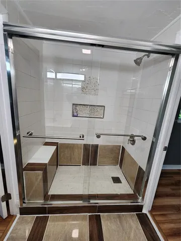 a view of empty room with wooden floor and window