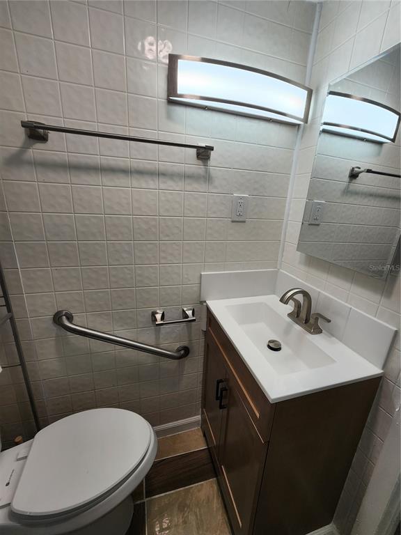 106 Southwest 6th Street Micanopy, FL 32667 - Photo 38 of 62 a bathroom with a sink a toilet and a mirror