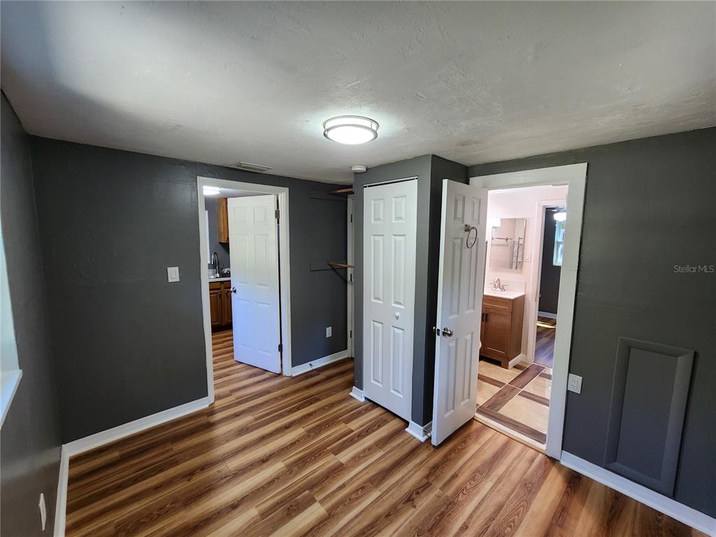 106 Southwest 6th Street Micanopy, FL 32667 - Photo 42 of 62 a view of a hallway with bathroom and wooden floor
