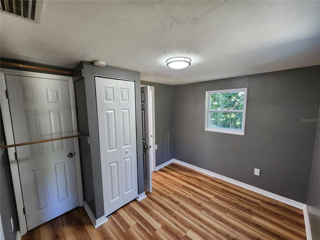 106 Southwest 6th Street Micanopy, FL 32667 - Photo 43 of 62 a bedroom with bed and wooden floor