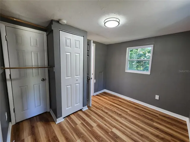 a kitchen with granite countertop wood cabinets stainless steel appliances and a window