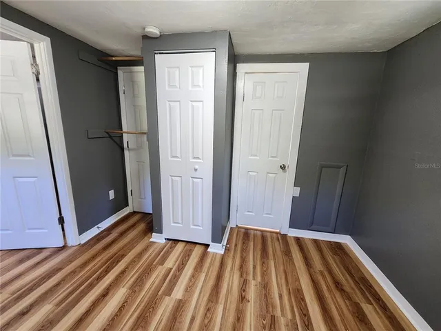 a view of a room with wooden floor