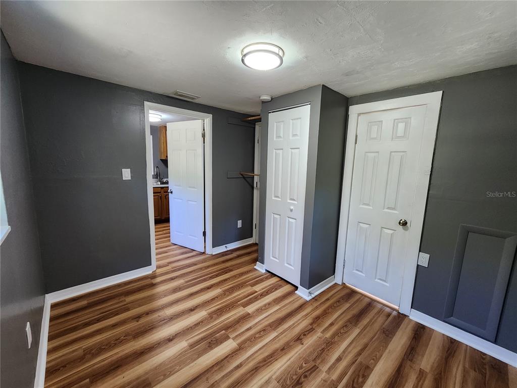 106 Southwest 6th Street Micanopy, FL 32667 - Photo 47 of 62 a view of a room with wooden floor and closet area