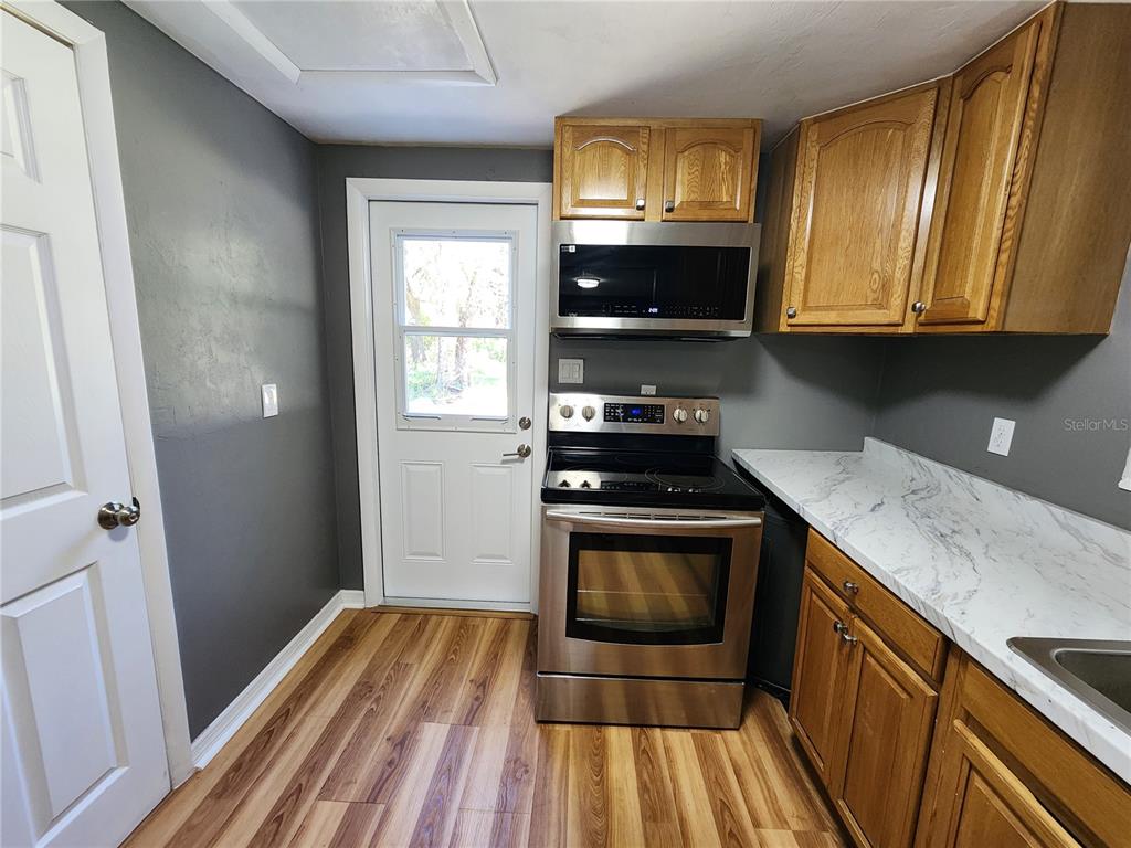 106 Southwest 6th Street Micanopy, FL 32667 - Photo 61 of 62 a kitchen with wooden floor and a sink