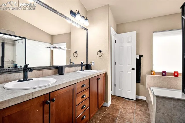 a bathroom with a sink double vanity and a mirror