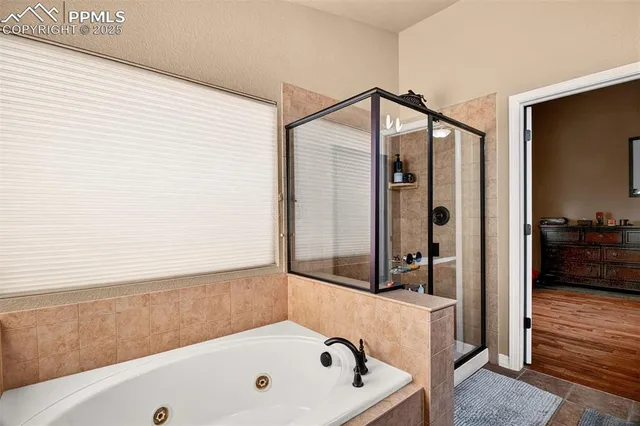 a bathroom with a tub and a shower