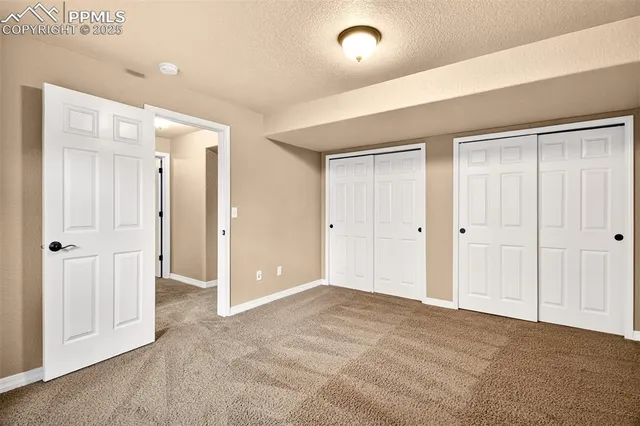 an empty room with closet and a bathroom