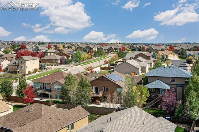 an aerial view of a houses with table and chairs