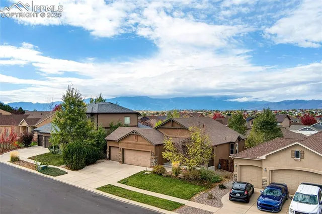 an aerial view of a house with garden space and street view