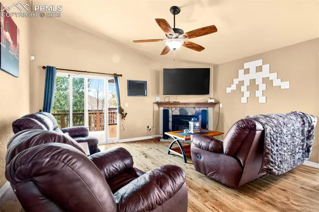 a living room with furniture a fireplace and a flat screen tv