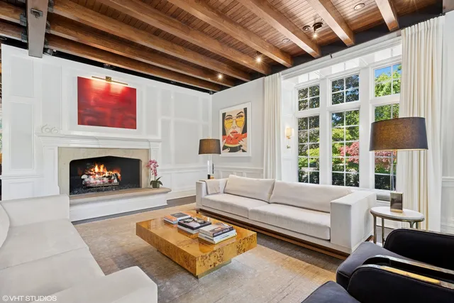 a living room with furniture wooden floor and a large window