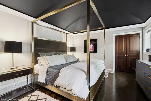 a bed sitting in a bedroom next to a window