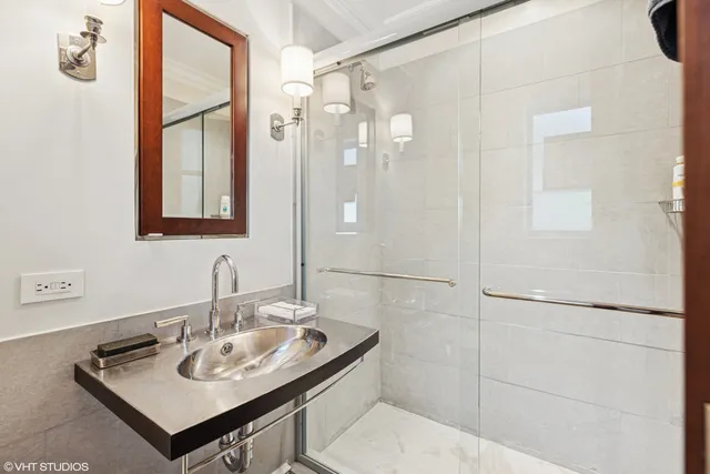 a bathroom with a granite countertop sink toilet and shower