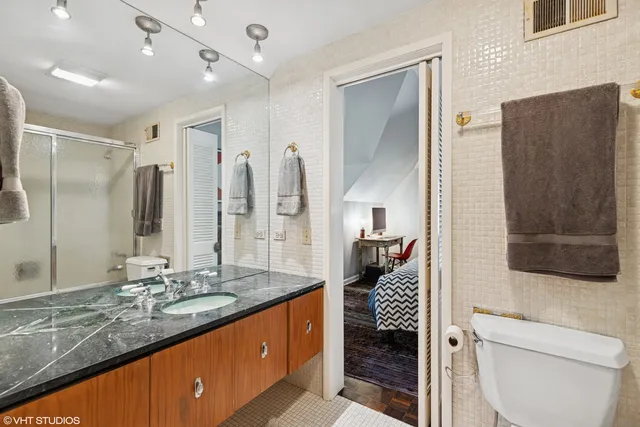 a bathroom with a sink a large mirror and a shower
