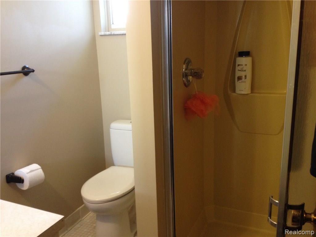 Second bathroom, off kitchen, near laundry/mud room/back door.