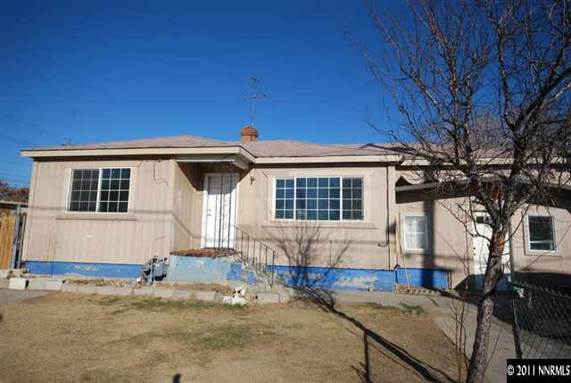 a front view of house with car parked