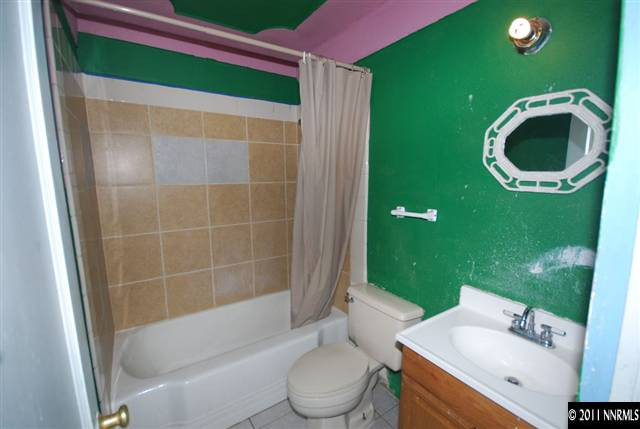 1231 East 9th Street Reno, NV 89512 - Photo 12 of 13 a bathroom with a sink and a mirror