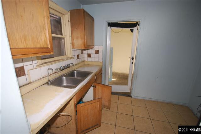 1231 East 9th Street Reno, NV 89512 - Photo 5 of 13 a kitchen with a sink cabinets and a window