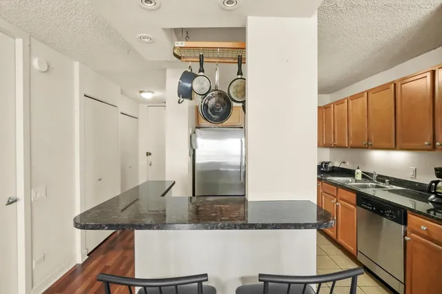 a kitchen with stainless steel appliances granite countertop a sink and cabinets