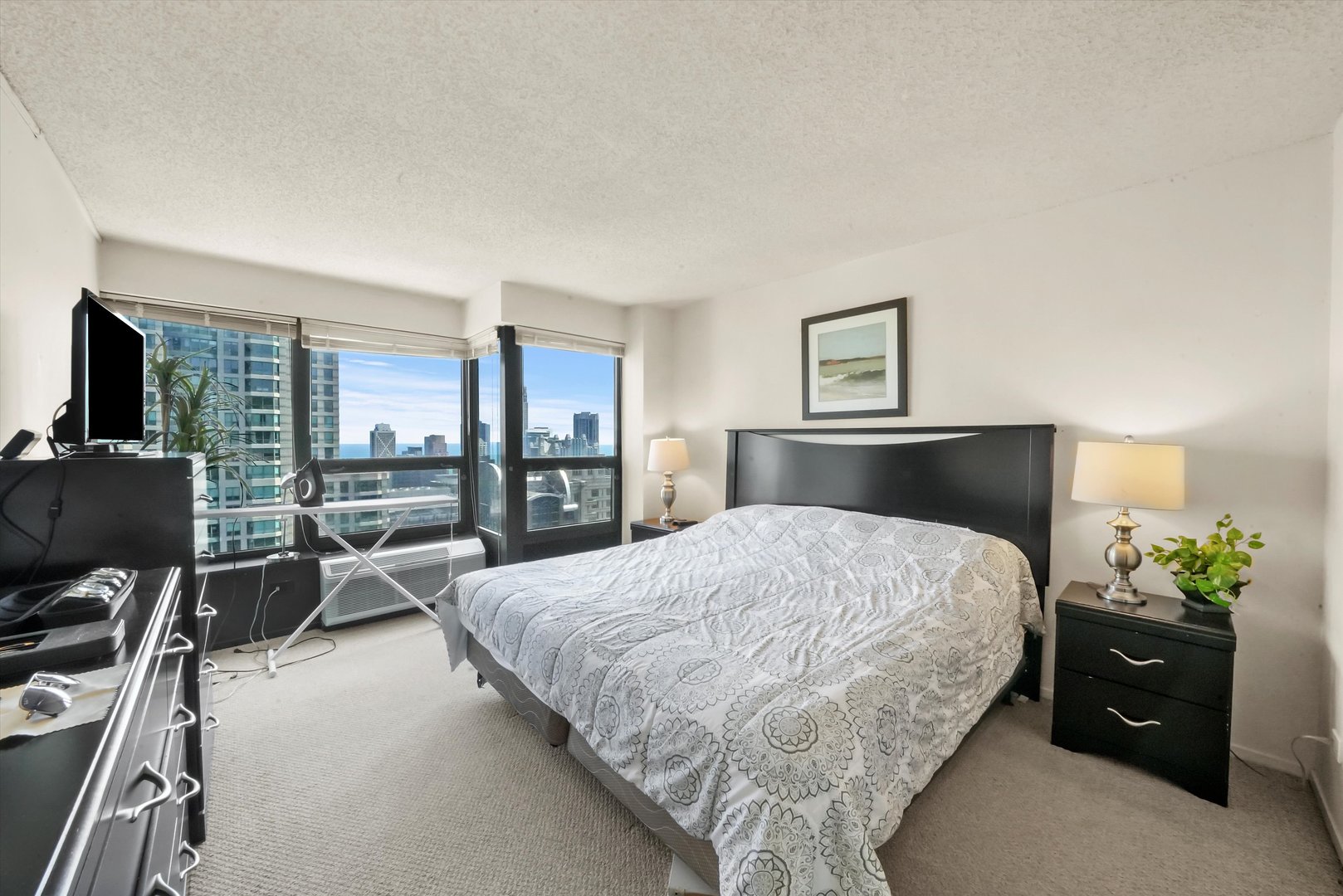 30 East Huron Street, Unit 5410 Chicago, IL 60611 - Photo 7 of 28 a bed room with a bed and a couch
