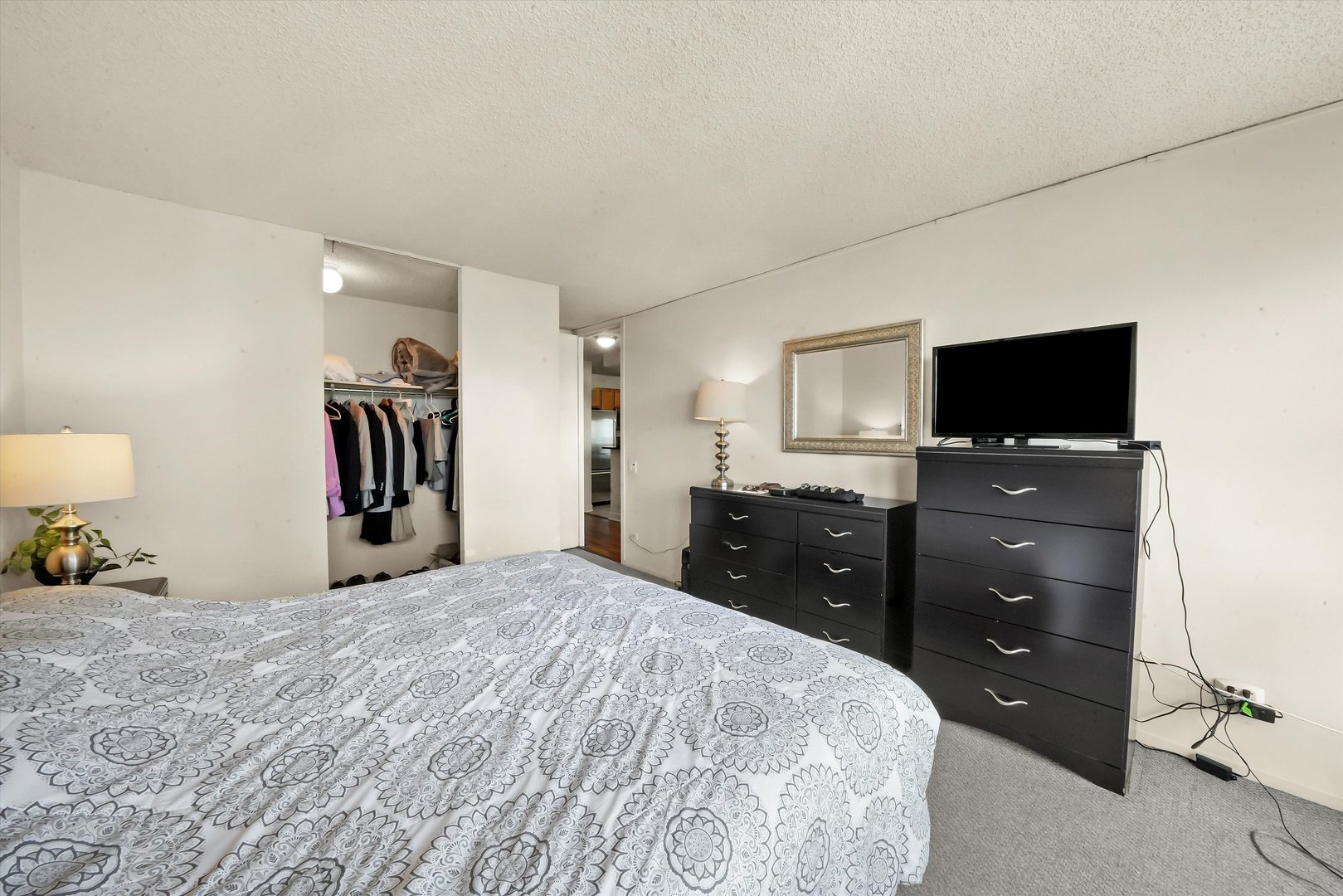 30 East Huron Street, Unit 5410 Chicago, IL 60611 - Photo 8 of 28 a bedroom with a bed and a flat screen tv