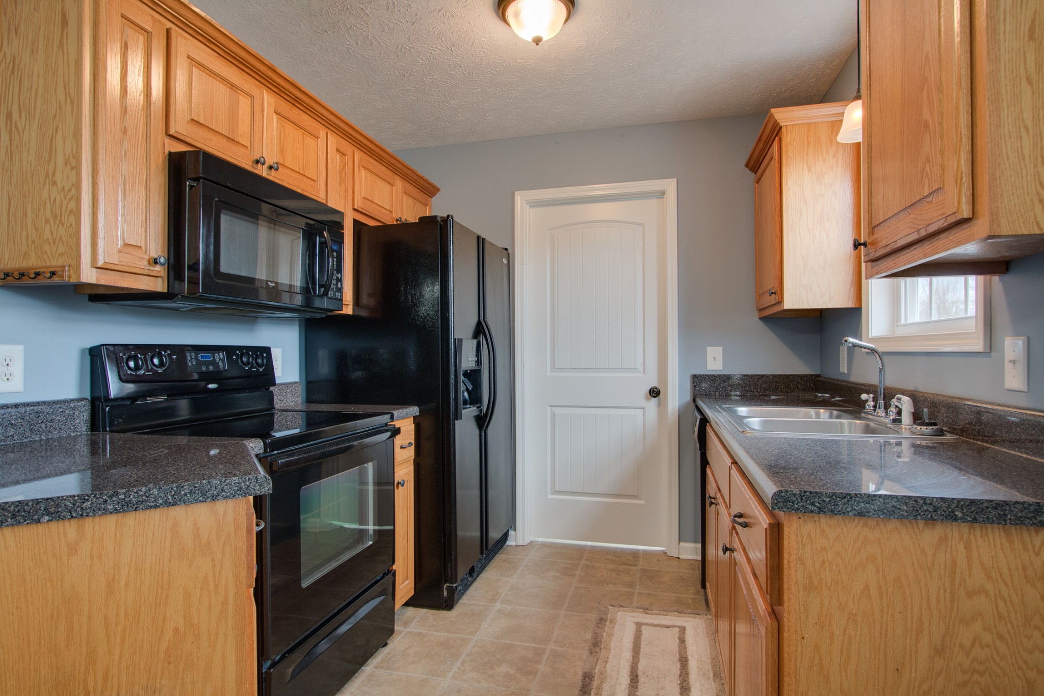 850 North Corinth Road Portland, TN 37148 - Photo 13 of 33 a kitchen with stainless steel appliances granite countertop a sink stove and refrigerator