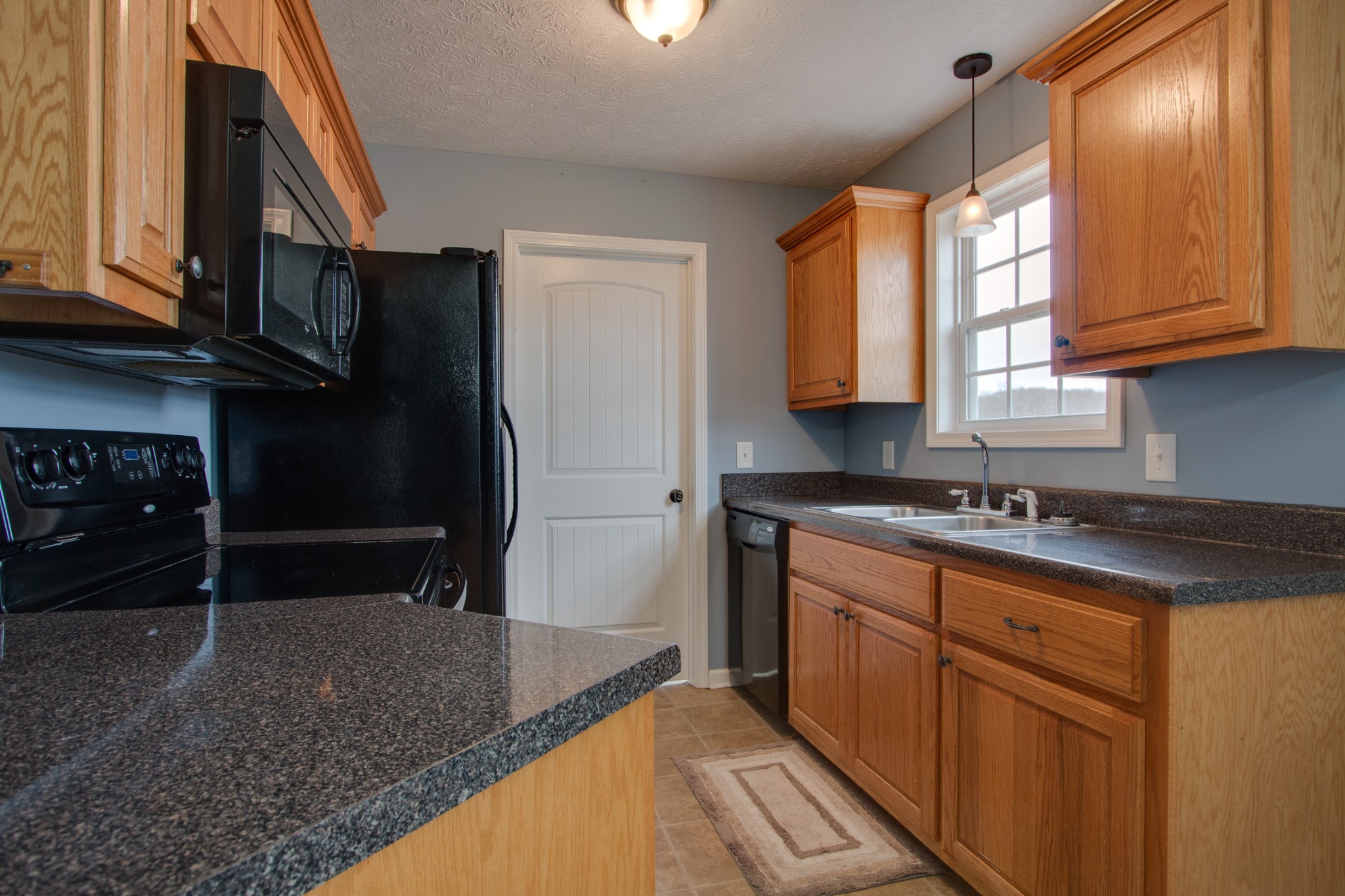 850 North Corinth Road Portland, TN 37148 - Photo 14 of 33 a kitchen with stainless steel appliances granite countertop a sink stove and cabinets