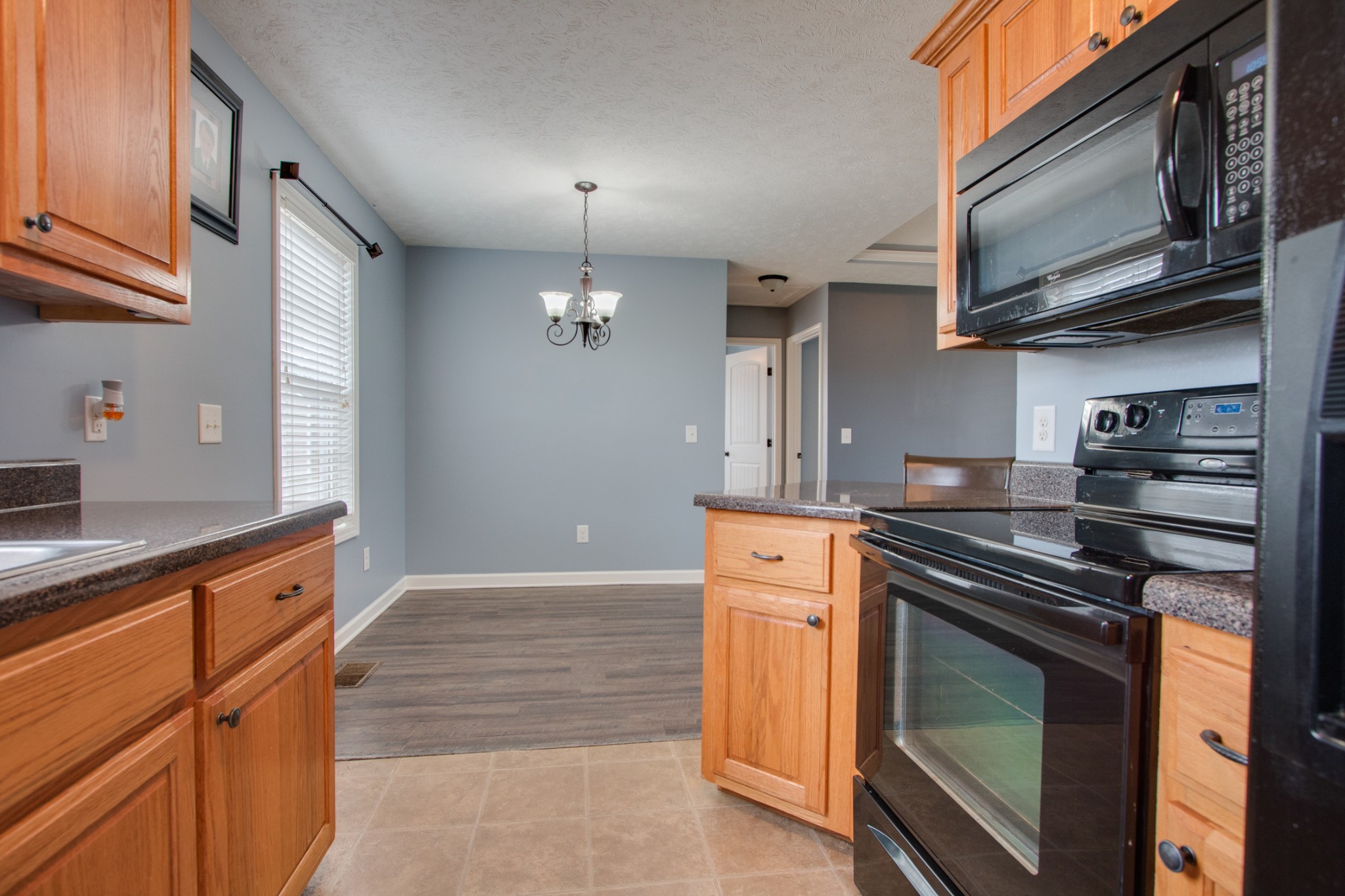 850 North Corinth Road Portland, TN 37148 - Photo 16 of 33 a kitchen with stainless steel appliances granite countertop a stove and a sink
