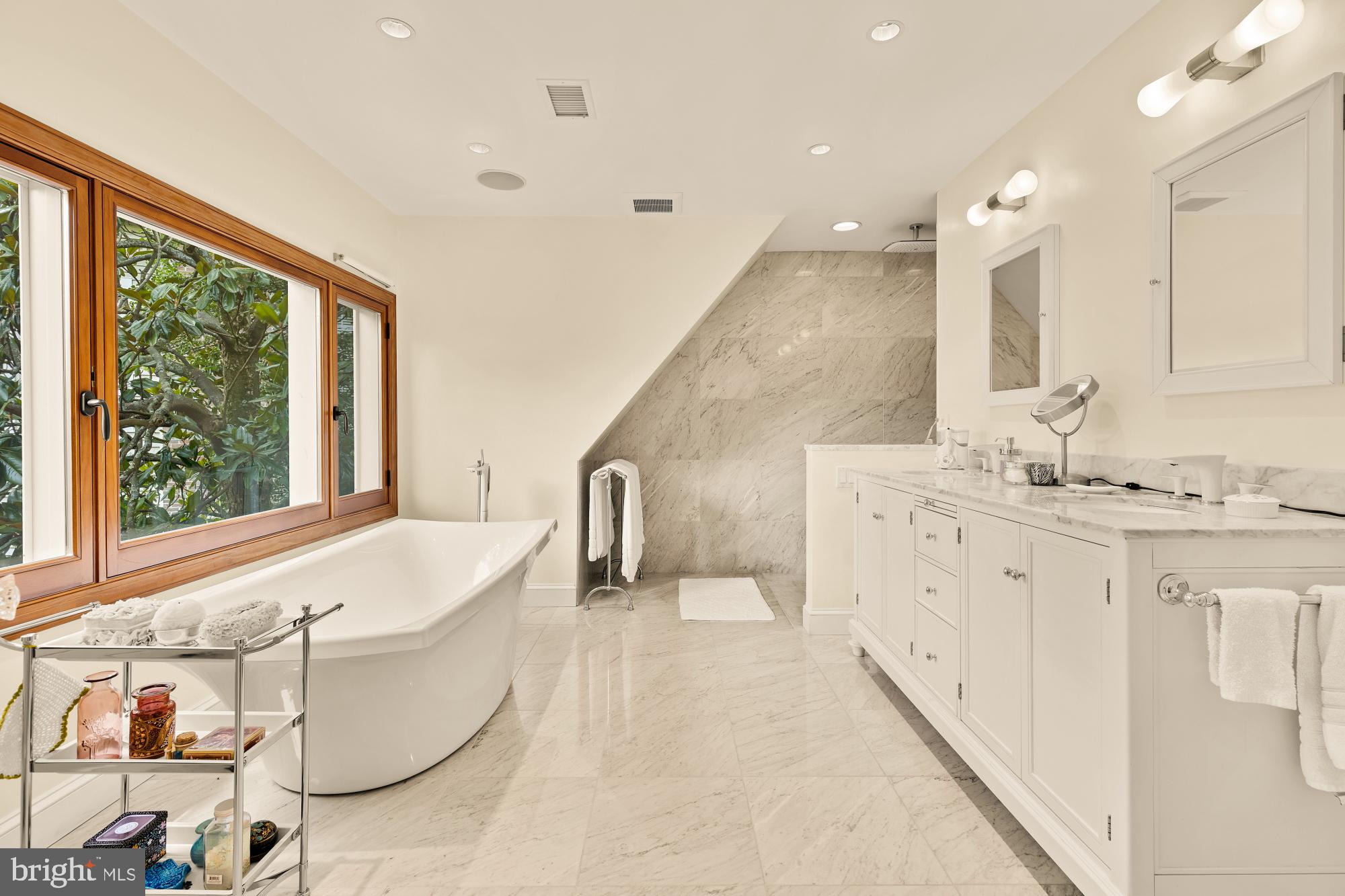 3111 Chain Bridge Road Northwest Washington, DC 20016 - Photo 39 of 71 a spacious bathroom with a granite countertop sink and a large mirror