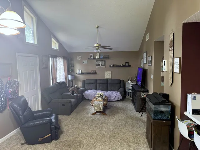 a bedroom with a bed and a ceiling fan