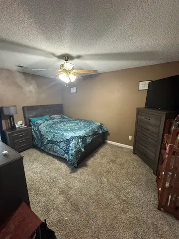 a bedroom with a bed and dresser