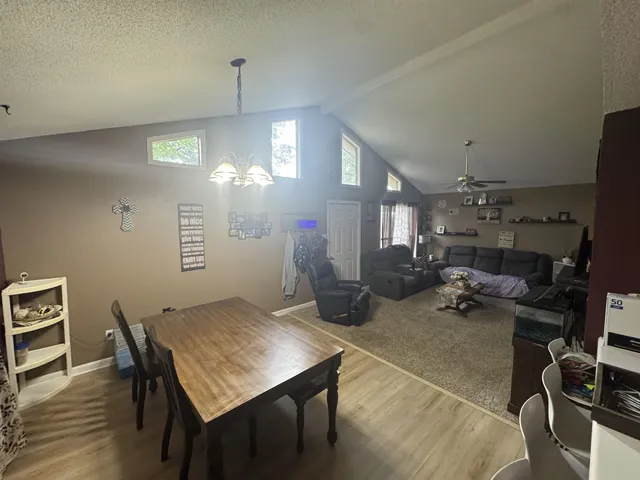 a view of a dining room with furniture and a chandelier