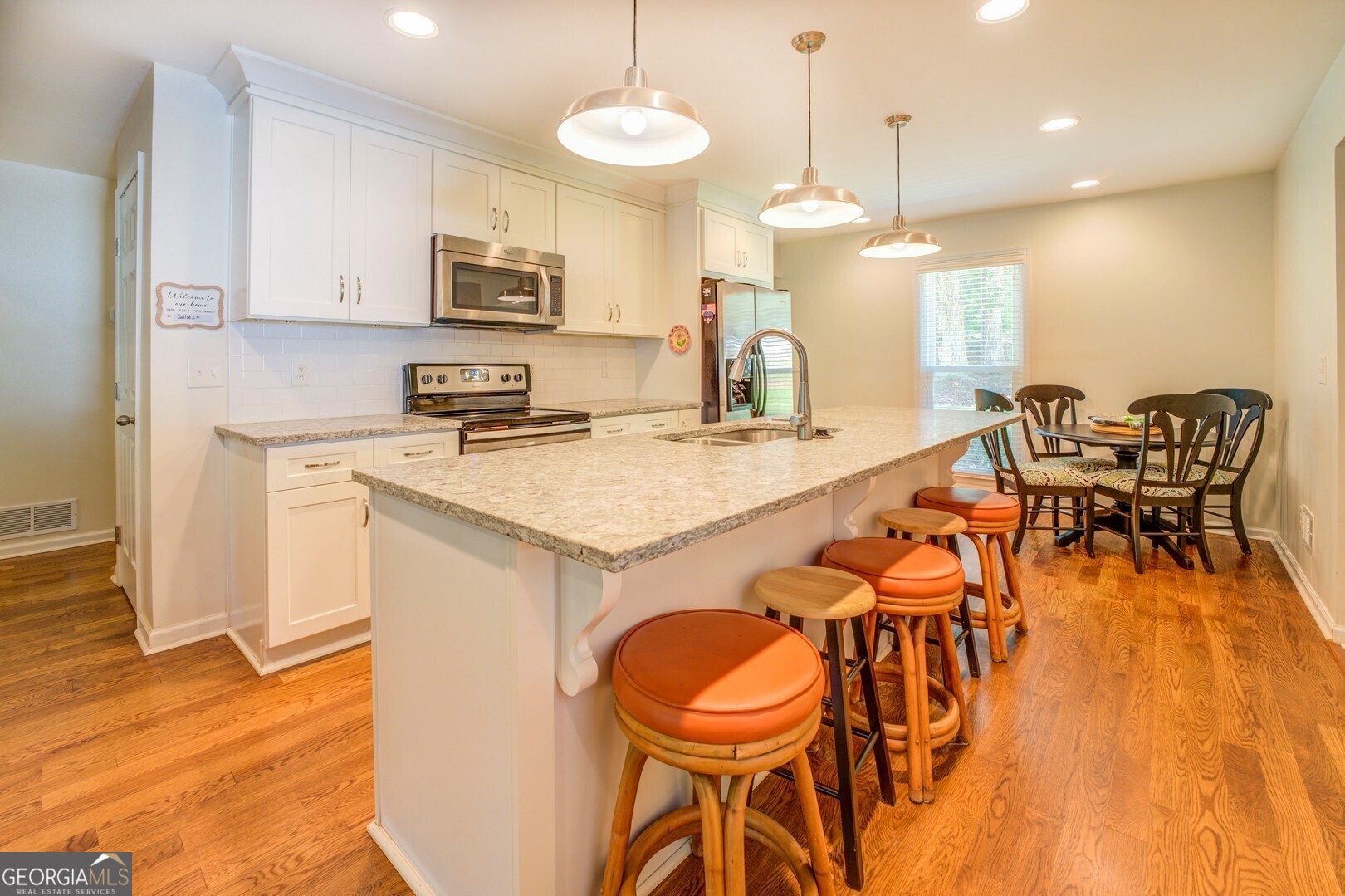 2601 Turtle Cove Monticello, GA 31064 - Photo 19 of 85 a kitchen with stainless steel appliances granite countertop a kitchen island a stove a table and chairs
