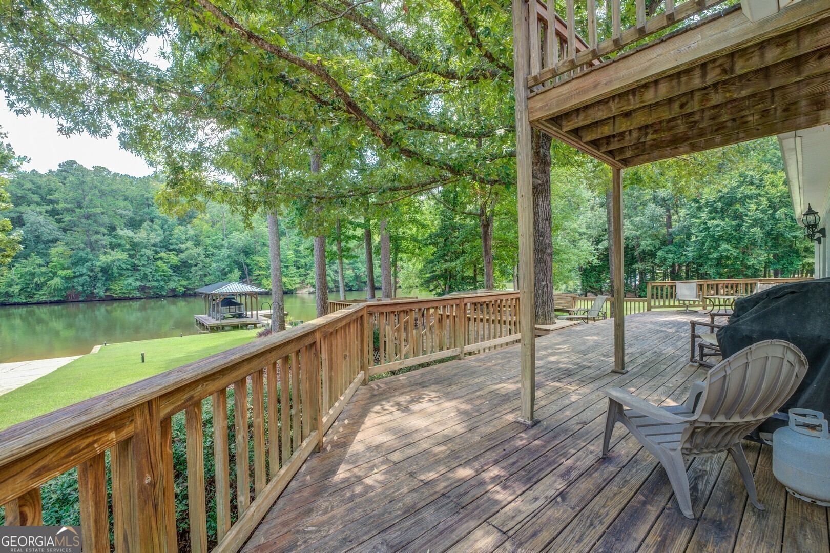 2601 Turtle Cove Monticello, GA 31064 - Photo 63 of 85 a view of a chair and table on the wooden deck