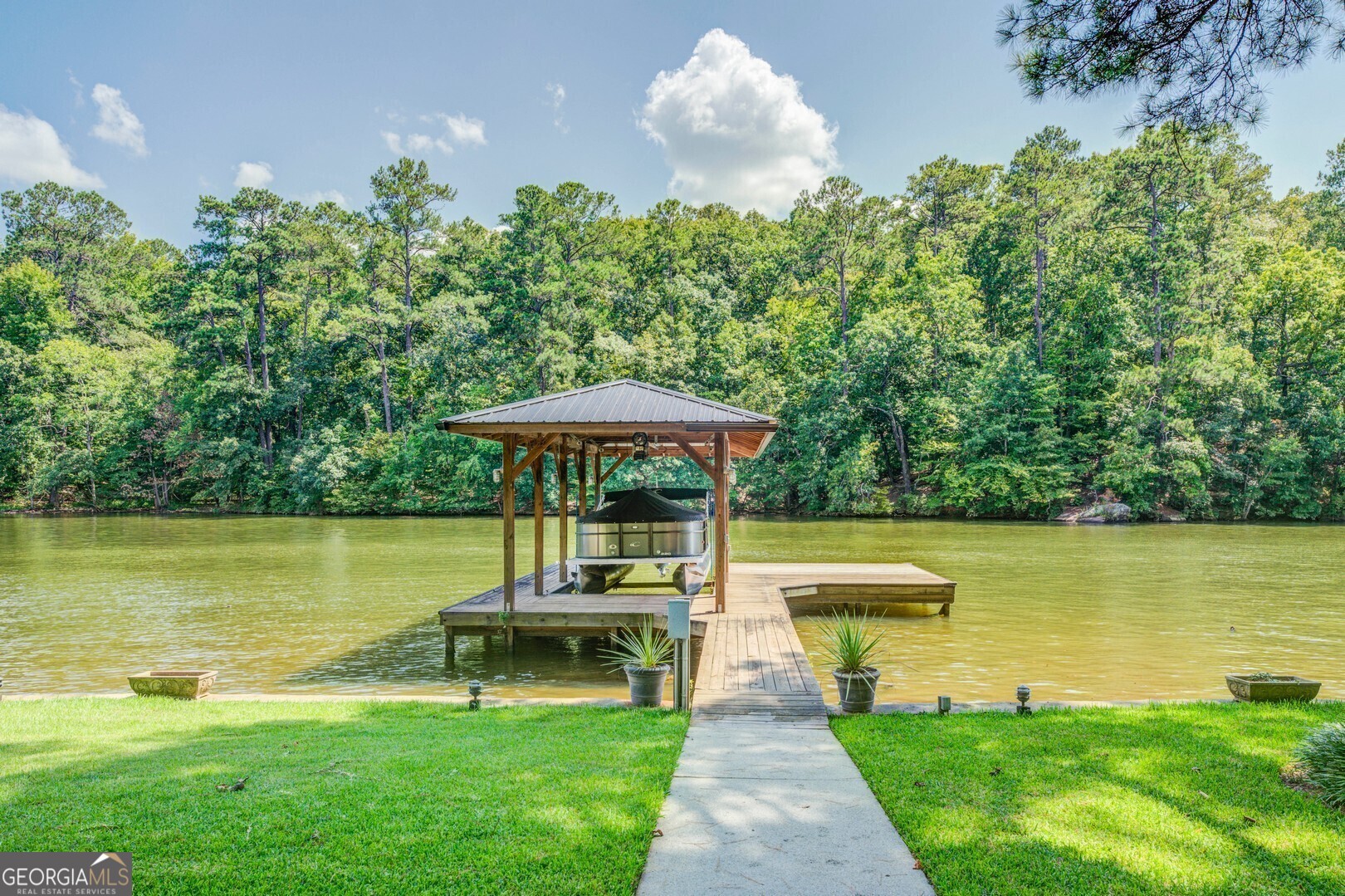 2601 Turtle Cove Monticello, GA 31064 - Photo 68 of 85 a view of a lake with a bench and trees