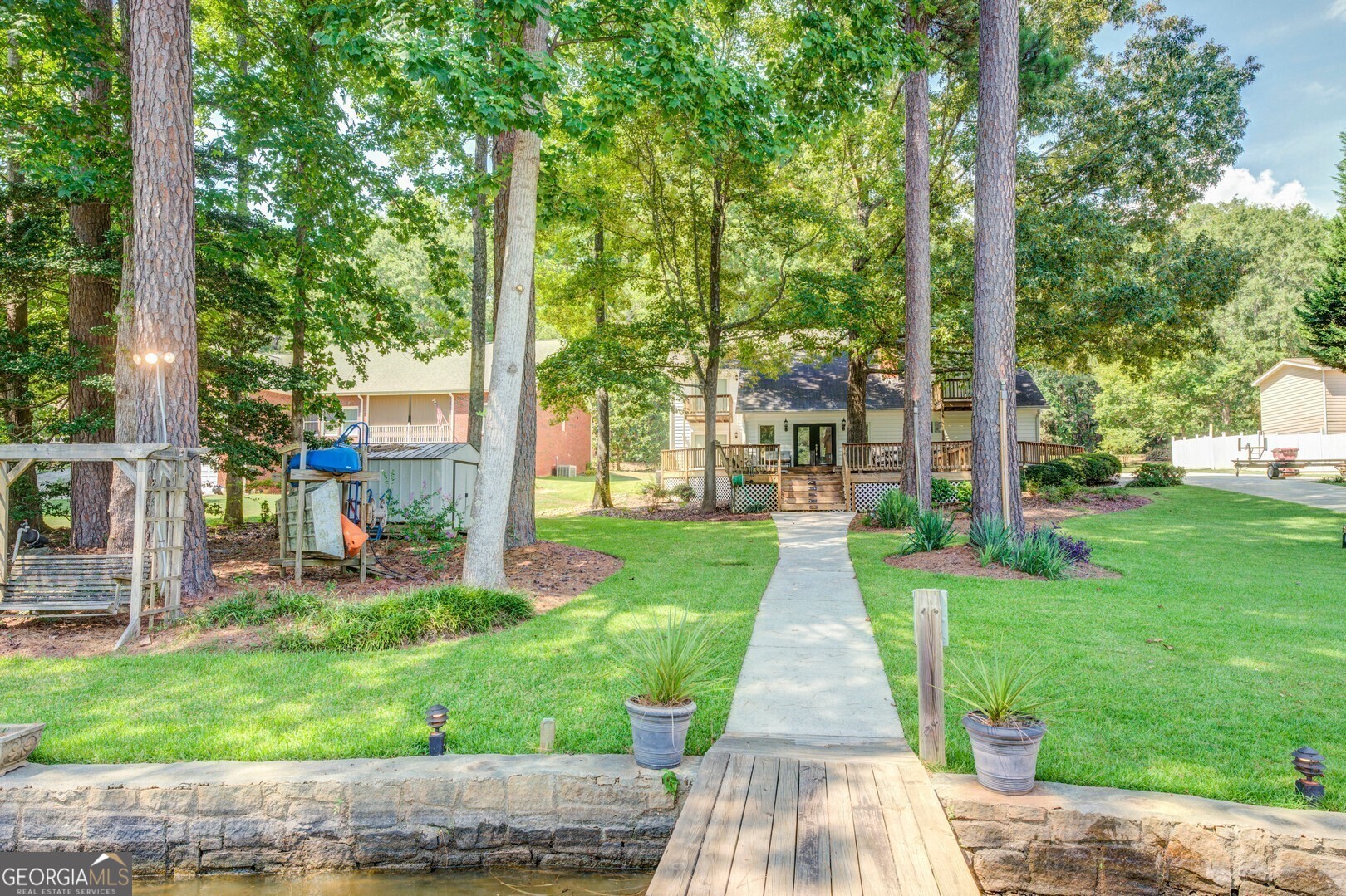 2601 Turtle Cove Monticello, GA 31064 - Photo 69 of 85 a front view of a house with a yard table and chairs