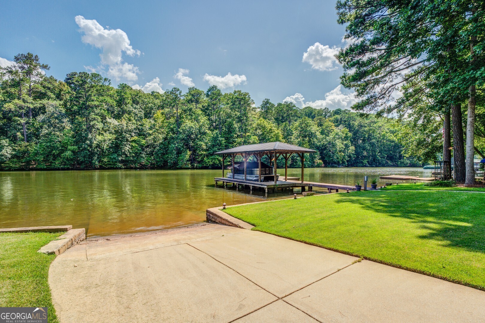 2601 Turtle Cove Monticello, GA 31064 - Photo 73 of 85 a view of a swimming pool and lounge chairs in back yard of the house