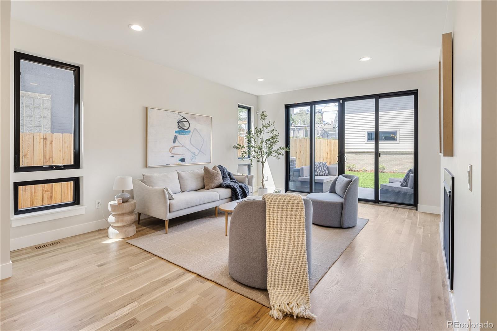 2143 High Street Denver, CO 80205 - Photo 11 of 43 a living room with furniture and large windows