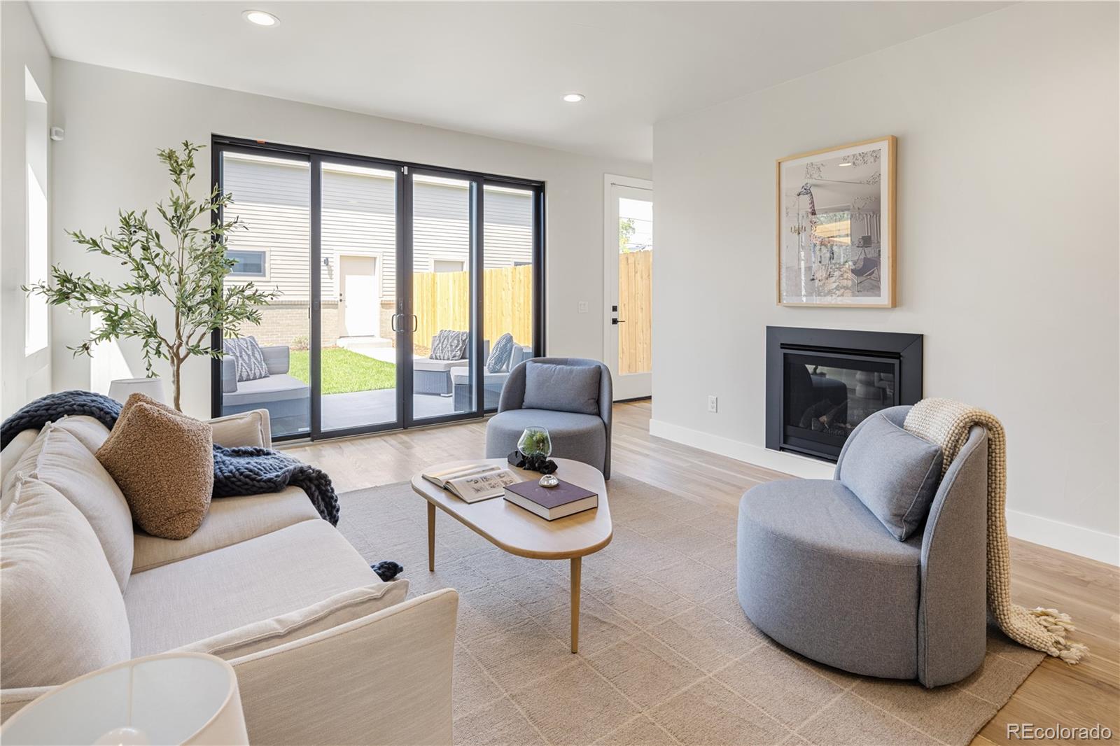 2143 High Street Denver, CO 80205 - Photo 13 of 43 a living room with furniture and a large window