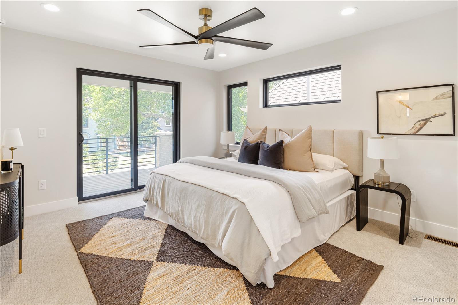 2143 High Street Denver, CO 80205 - Photo 18 of 43 a bedroom with a large bed and a window