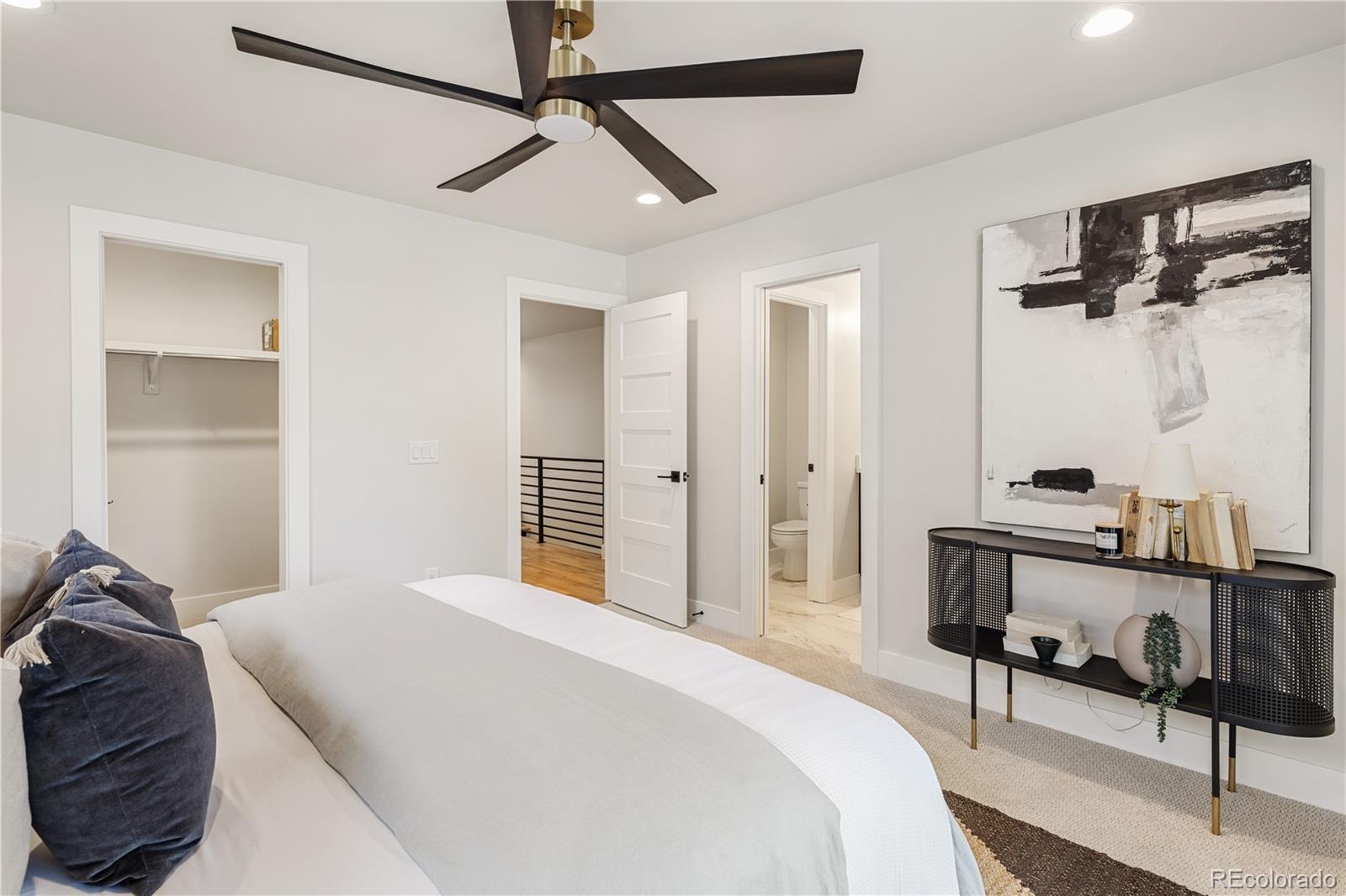 2143 High Street Denver, CO 80205 - Photo 19 of 43 a bedroom with a bed and a table