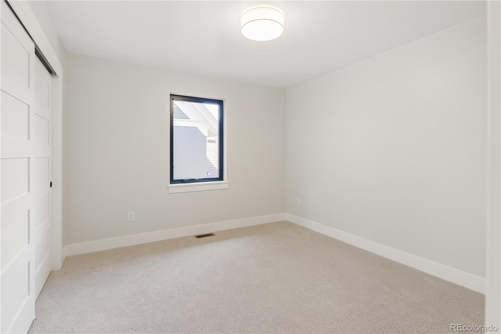 2143 High Street Denver, CO 80205 - Photo 27 of 43 an empty room with a window