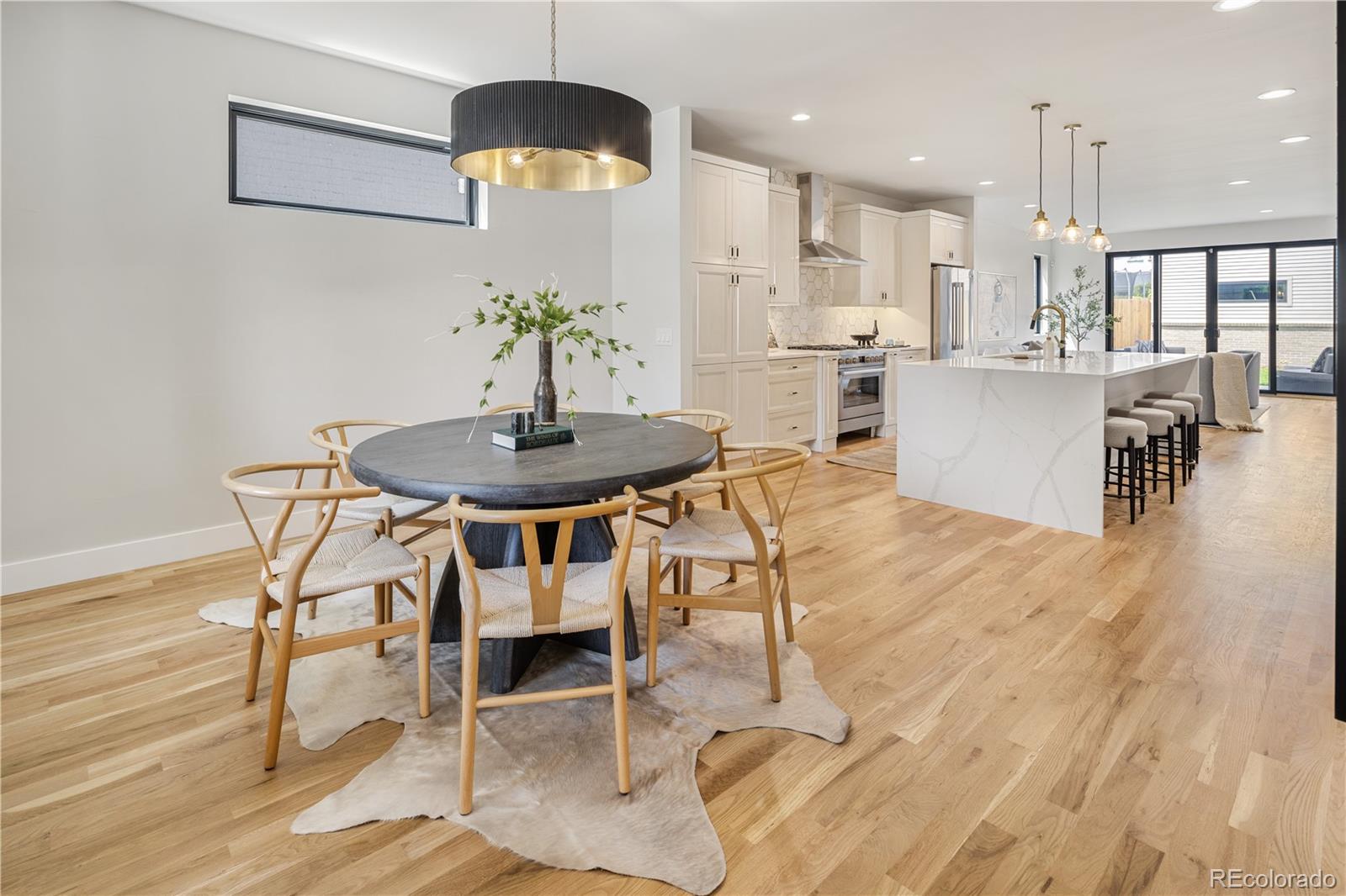 2143 High Street Denver, CO 80205 - Photo 4 of 43 a view of a dining room with furniture and wooden floor