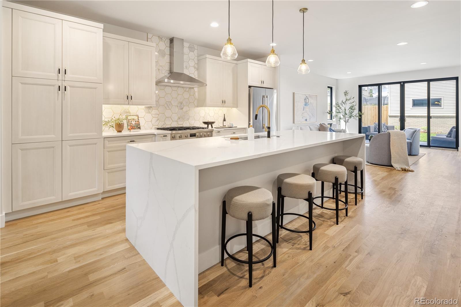 2143 High Street Denver, CO 80205 - Photo 5 of 43 a large kitchen with lots of counter space and windows