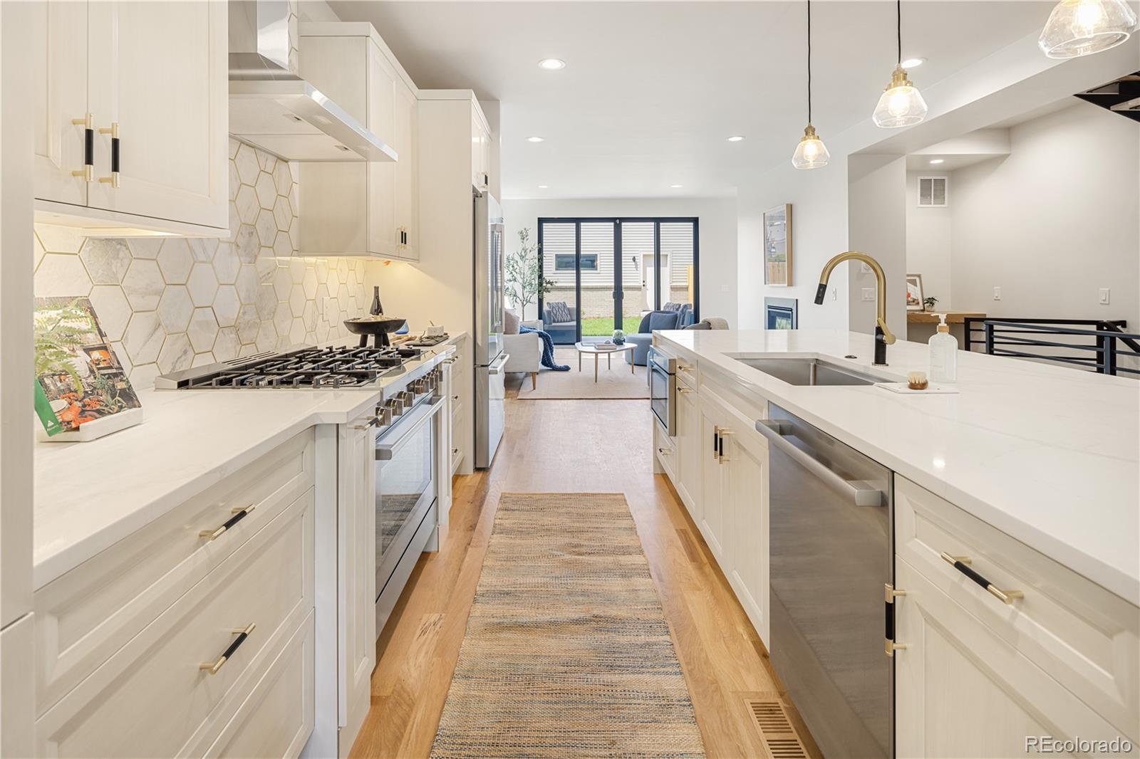 2143 High Street Denver, CO 80205 - Photo 6 of 43 a large kitchen with stainless steel appliances granite countertop a stove and a sink
