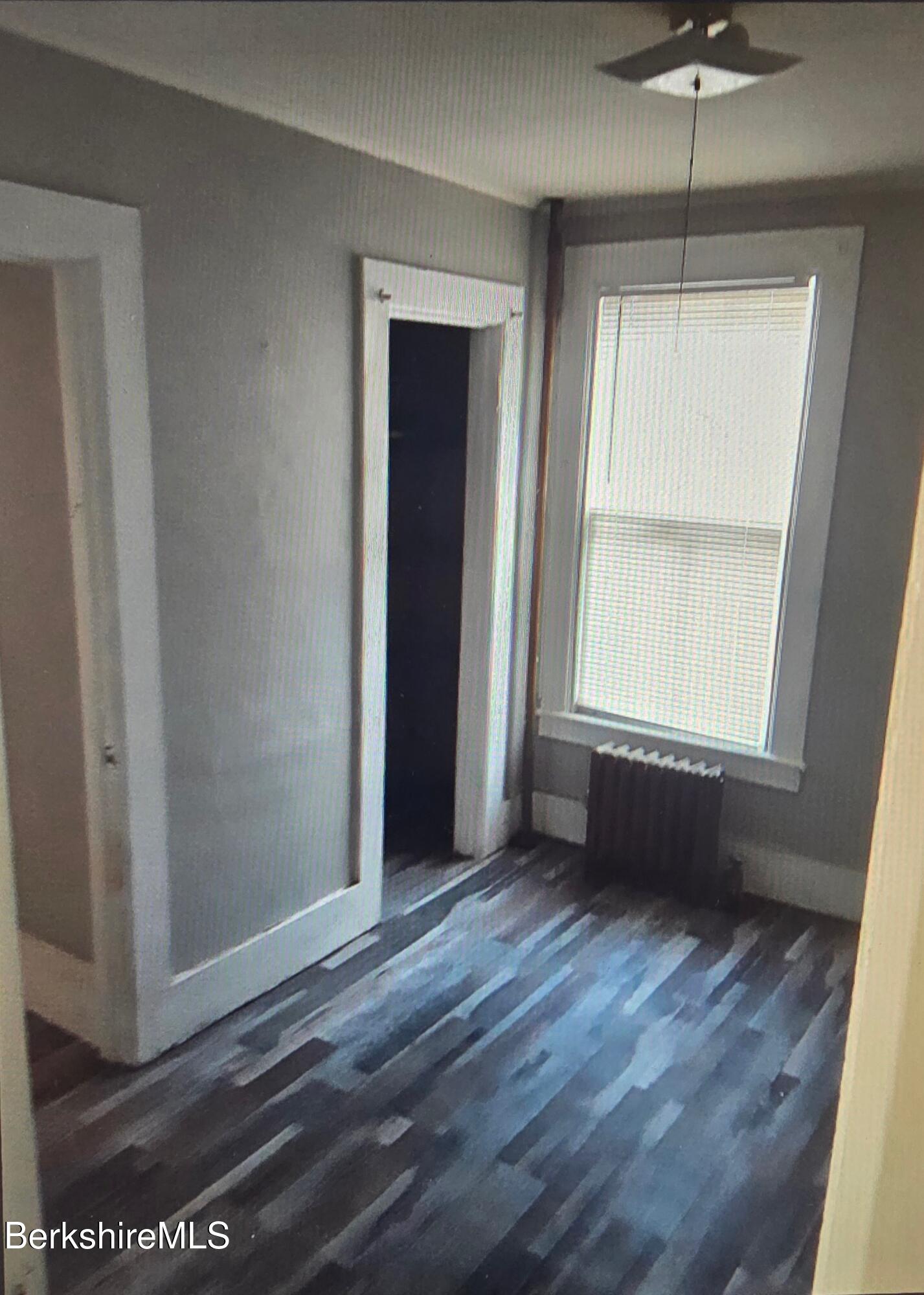 301 Walnut Street North Adams, MA 01247 - Photo 7 of 12 a view of an empty room with a window and wooden floor