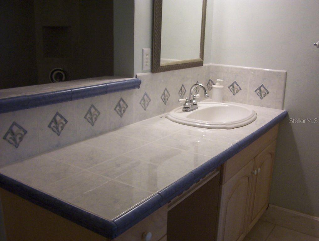 13650 Gulf Boulevard, Unit 304 Madeira Beach, FL 33708 - Photo 42 of 63 a bathroom with a sink and a mirror