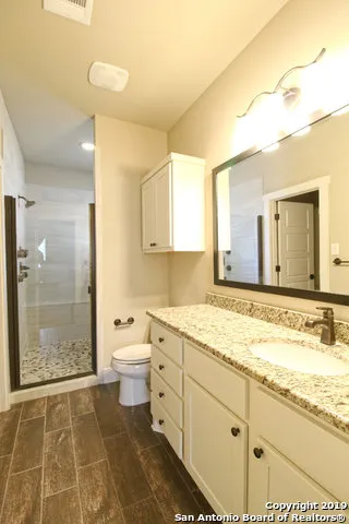 a bathroom with a granite countertop sink mirror and a